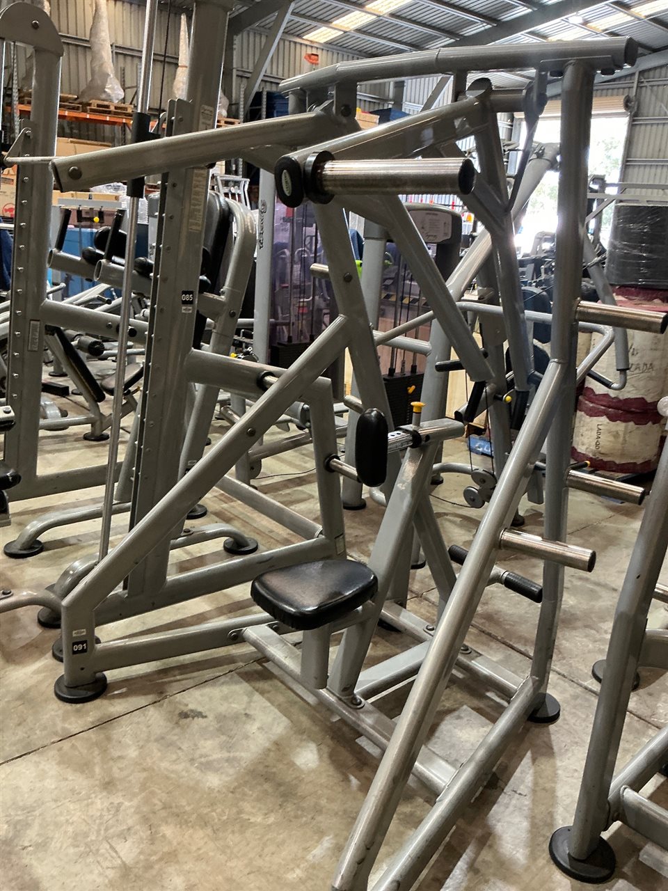 Plate-Loaded Seated Machine with Overhead Lever Arm and Chest Pad