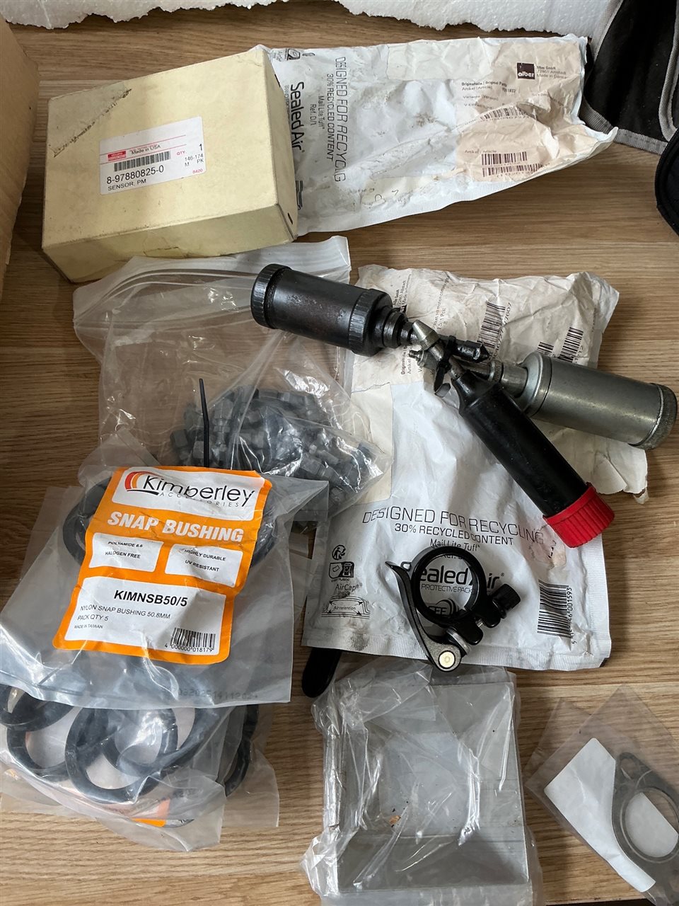 Quantity of 3 Mini Grease Guns and Quantity Car Parts , Bushings  etc.