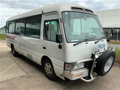 Toyota Coaster Bus - Series 50 - Year 2004 (05) Diesel -6 Speed Manual - 310,701 Kilometres Showing ,21 Seater Including Driver -Bull Bar , Spotlights , Air Conditioned - Side Auto Matic Door ,Gme 2 Way Radio , Sold Unregistered -No Plates - Previous Registration Number x Q A-106 - GVM 4990 / Gcm 6990 Thumbnail